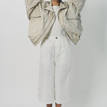 Alternate front view of desert colima zip up hoodie on model wearing white shirt and pants, against a white background.