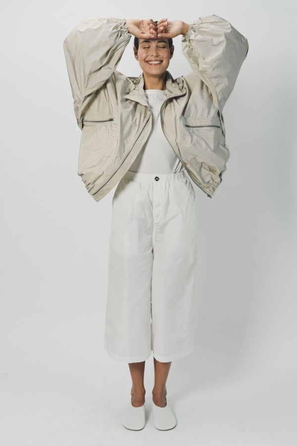 Alternate front view of desert colima zip up hoodie on model wearing white shirt and pants, against a white background.