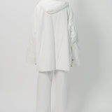 Back view of off white condor rev jacket on model wearing white pants, against a white background.