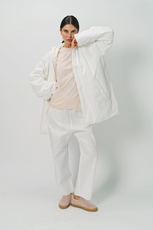 Alternate front view of off white condor rev jacket on model wearing white pants, against a white background.