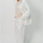 Hooded view of off white condor rev jacket on model wearing white pants and pink shirt, against a white background.