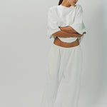 Front view of off white tower sweatpants on model wearing white sweatshirt, against a white background.