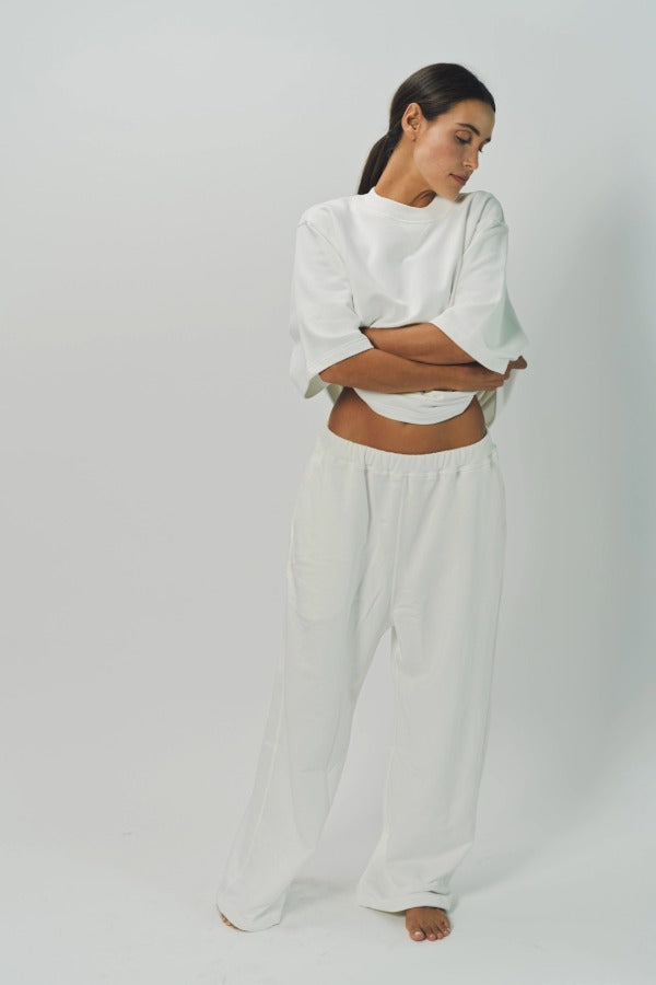 Front view of off white tower sweatpants on model wearing white sweatshirt, against a white background.
