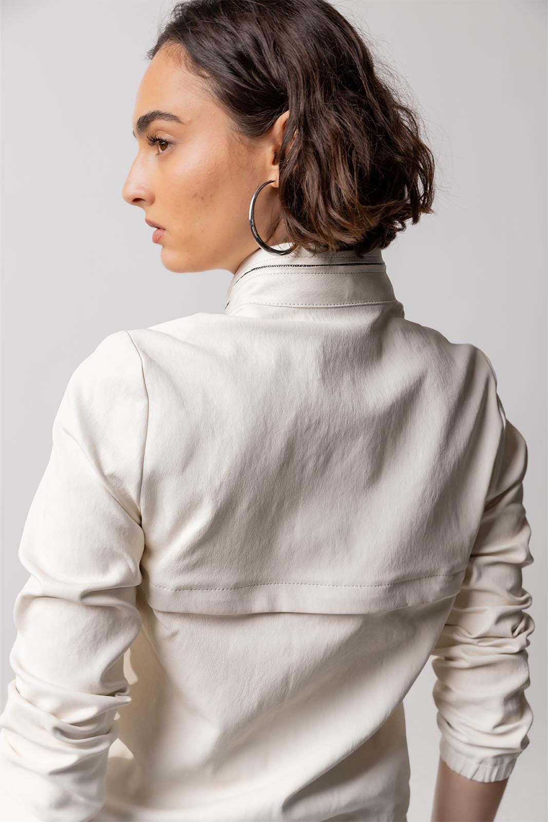 Back closeup view of white my way jacket on model against a white background.