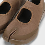 Front closeup view of chocolate tabi sandal on white background, with no model shown.