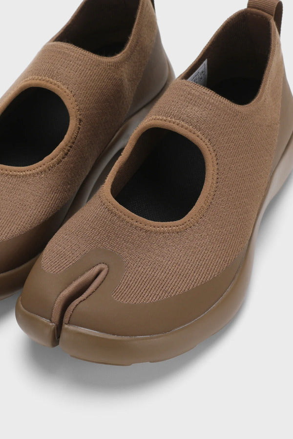 Front closeup view of chocolate tabi sandal on white background, with no model shown.