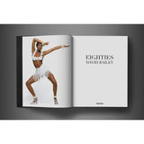 Open view of taschen david bailey eighties book on charcoal background.