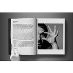 Open view of taschen david bailey eighties book on charcoal background.