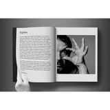 Open view of taschen david bailey eighties book on charcoal background.