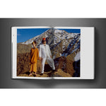 Open view of taschen david bailey eighties book on charcoal background.