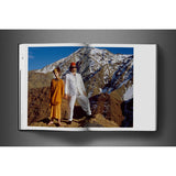 Open view of taschen david bailey eighties book on charcoal background.