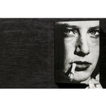 Front view of taschen helmut newton's Legacy book on black background.