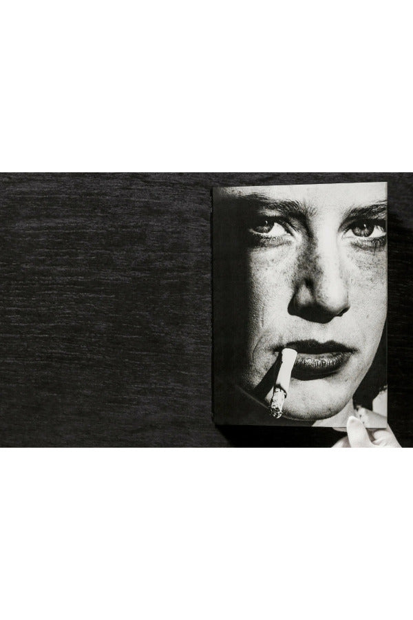 Front view of taschen helmut newton's Legacy book on black background.