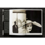Open view of taschen helmut newton's book Legacy on black background.