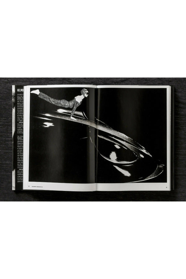 Open view of taschen helmut newton's Legacy book on black background.