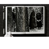Open view of taschen helmut newton's Legacy book on black background.