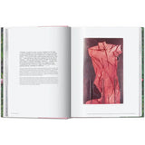 Open book view of taschen julian schnable book on white background.