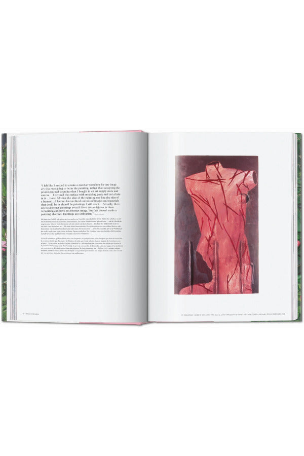 Open book view of taschen julian schnable book on white background.