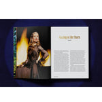 Open view of taschen life hollywood book on blue background.