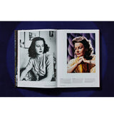 Open view of taschen hollywood book on blue background.