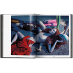 Open view of taschen mert atlas and marcus pigott book on white background.