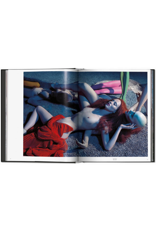 Open view of taschen mert atlas and marcus pigott book on white background.