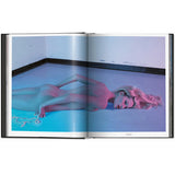 Open view of taschen mert atlas and marcus pigott book on white background.