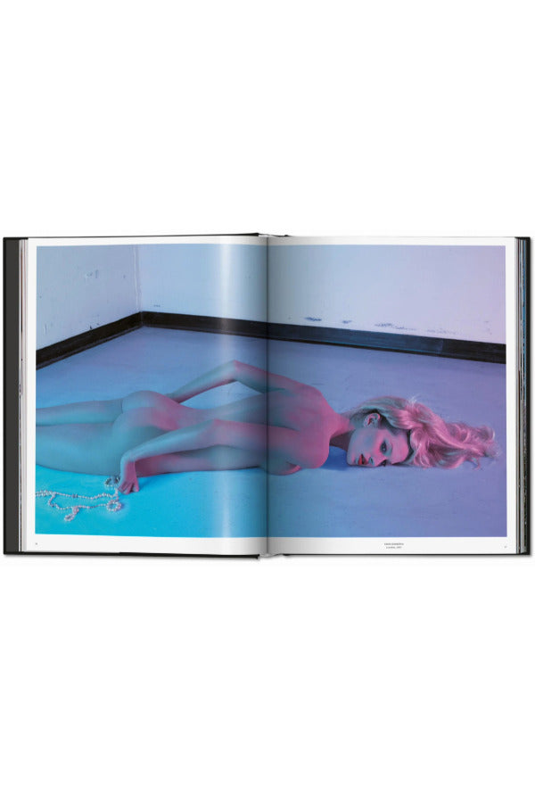 Open view of taschen mert atlas and marcus pigott book on white background.