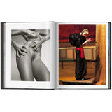 Open view of taschen mert atlas and marcus pigott book on white background.