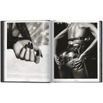 Open view of taschen mert atlas and marcus pigott book on white background.