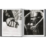 Open view of taschen mert atlas and marcus pigott book on white background.