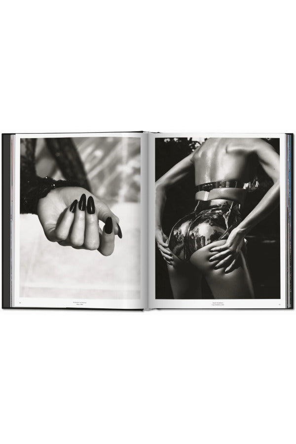 Open view of taschen mert atlas and marcus pigott book on white background.