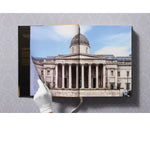 Open view of taschen national gallery paintings, people book on light colored tablecloth