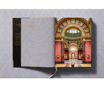 Open view of taschen national gallery paintings, people book on light colored tablecloth.