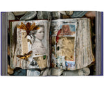 Open view of taschen peter beard book on white background.