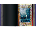 Open view of taschen peter beard book on white background.