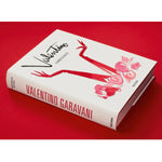 Side view of taschen Valentino book on red background.