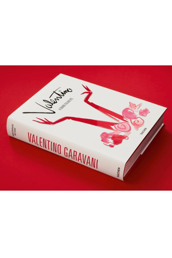 Side view of taschen Valentino book on red background.