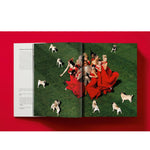 Open book view of taschen valentino book on red background.