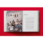 Open book view of taschen valentino book on red background.