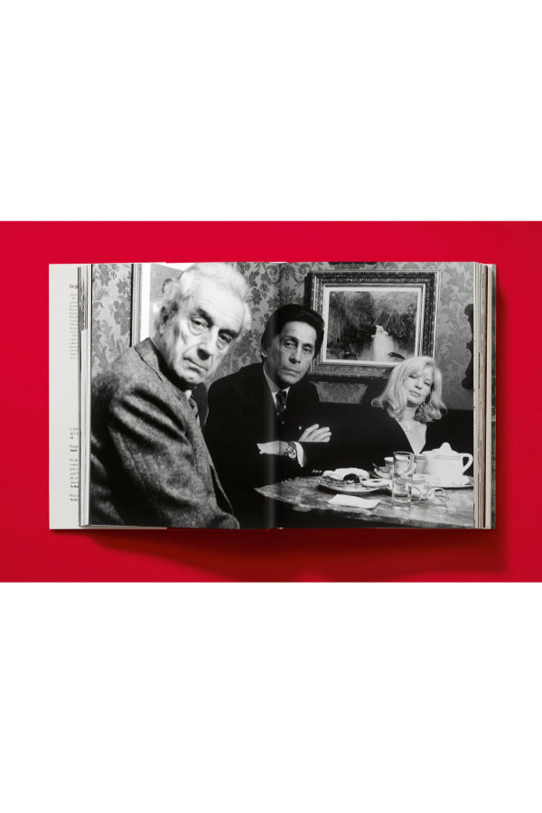Open book view of taschen valentino book on red background.