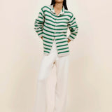 Front view of fern/white costeau stripe cardigan on model wearing white pants and heels, against a white background.
