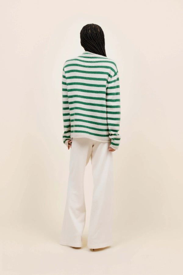 Back view of fern/white costeau stripe cardigan on model wearing white pants and heels, against a white background.