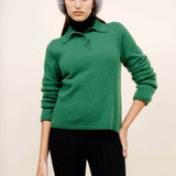 Front closeup view of fern laurel polo on model wearing black leggings and a beanie, against a white background