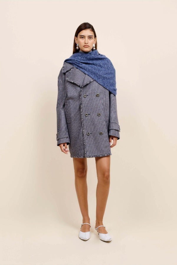 Front view of storm marl triangle body scarf on model wearing blue coat and flats, against a white background.