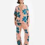 Front view of multi floral the elder statesman sun and moon cardigan on model wearing matching pants and heels, against a white background.