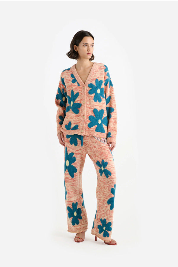 Front view of multi floral the elder statesman sun and moon cardigan on model wearing matching pants and heels, against a white background.