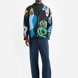 Front view of multi mythical creatures on modewl wearing blue trousers and black sandals against a white background.