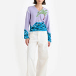 Front view of multi palm beach cardigan on model wearing white trousers and white wedge heels, against a white background.