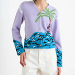 Front closeup picture of multi palm beach cardigan on model wearing white trousers, against a white background.